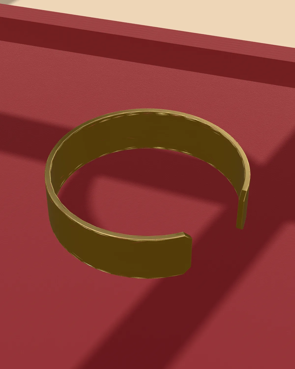 Brass cuff laid flat on velvet, close