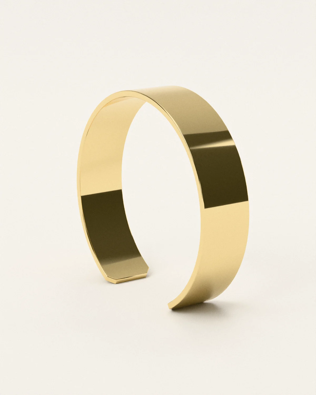 Brass cuff, standing on pale paper